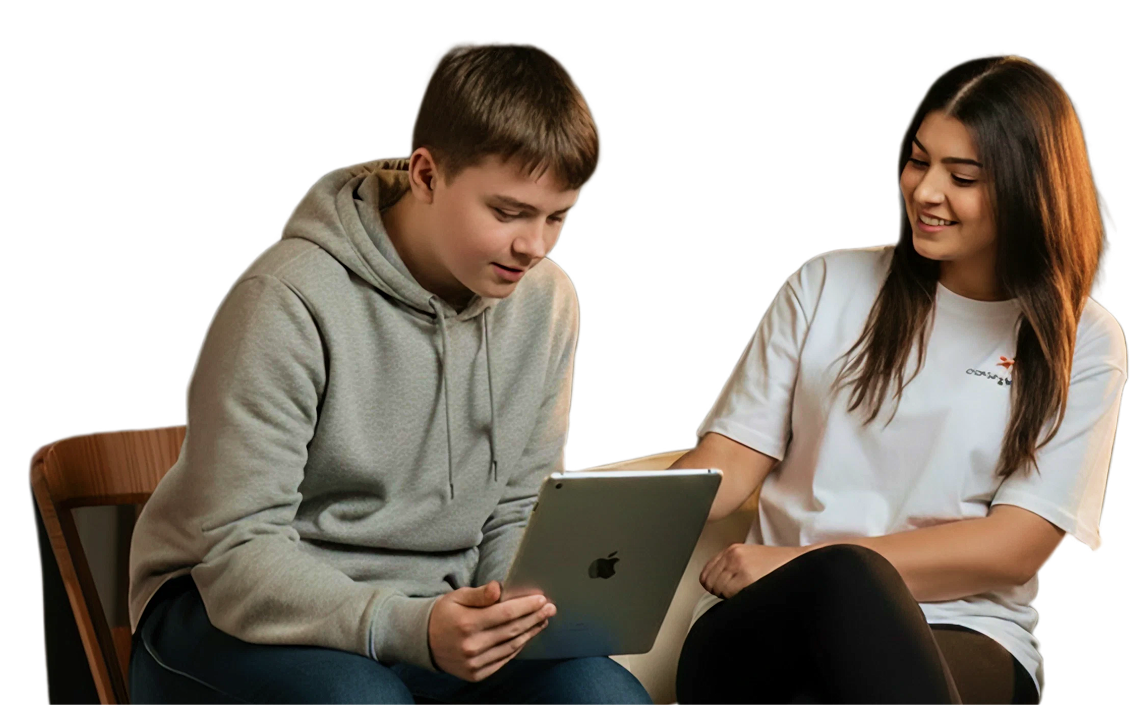 A support worker helping a young person use a tablet